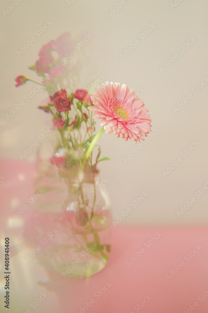 Fototapeta premium Creative abstract natural background.A bouquet of delicate pink flowers in a vase photographed through a prism for a Surreal Prisming Shot Of. The concept of the arrival of spring.