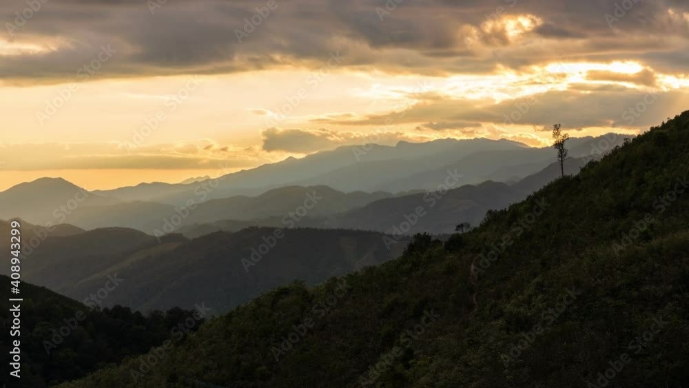 Time lapse view of sun rays emerging though clouds in mountain landscape in Huai Thon Village, Nan, Thailand. Footage timelapse nature landscape view and dramatic colored sky. Time lapse view of sun rays emerging though clouds in mountain landscape in Huai Thon Village, Nan, Thailand. Footage timelapse nature landscape view and dramatic colored sky.