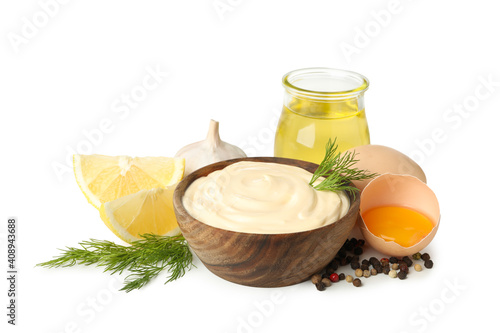 Bowl of mayonnaise and ingredients for cooking isolated on white background photo