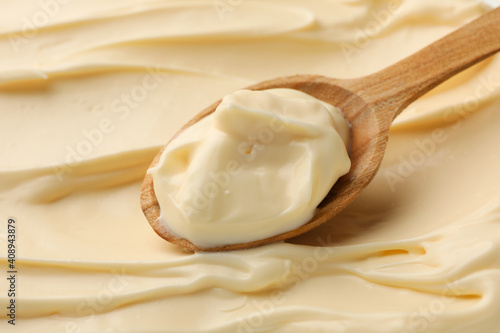 Mayonnaise sauce texture with wooden spoon, close up