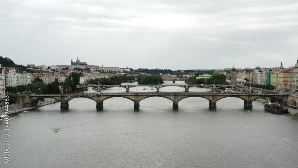 Aerial push-out of bridge over Vltava River and Prague cityscape Aerial push-out of bridge over Vltava River and Prague cityscape