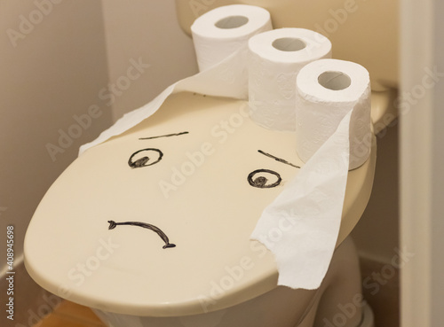 toilet paper on the sad face toilet. Constipation concept