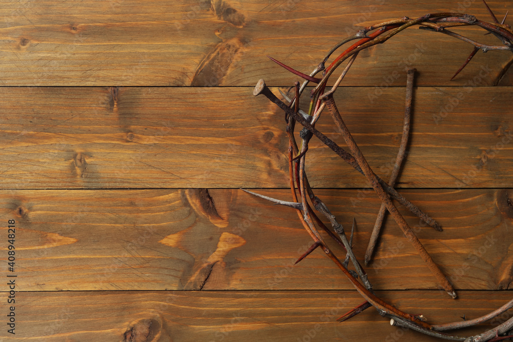 Crown of thorns and nails on wooden table, flat lay with space for text. Easter attributes Crown of thorns and nails on wooden table, flat lay with space for text. Easter attributes