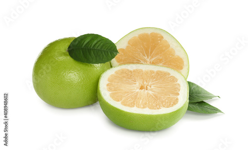 Whole and cut sweetie fruits with green leaves on white background