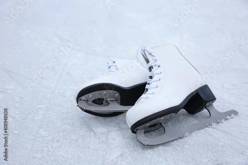 Pair of figure skates on ice. Winter outdoors activities