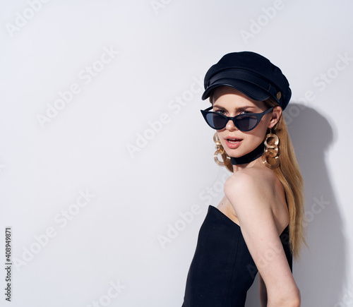 Elegant woman in black dress with dark glasses fashion Glamor light background