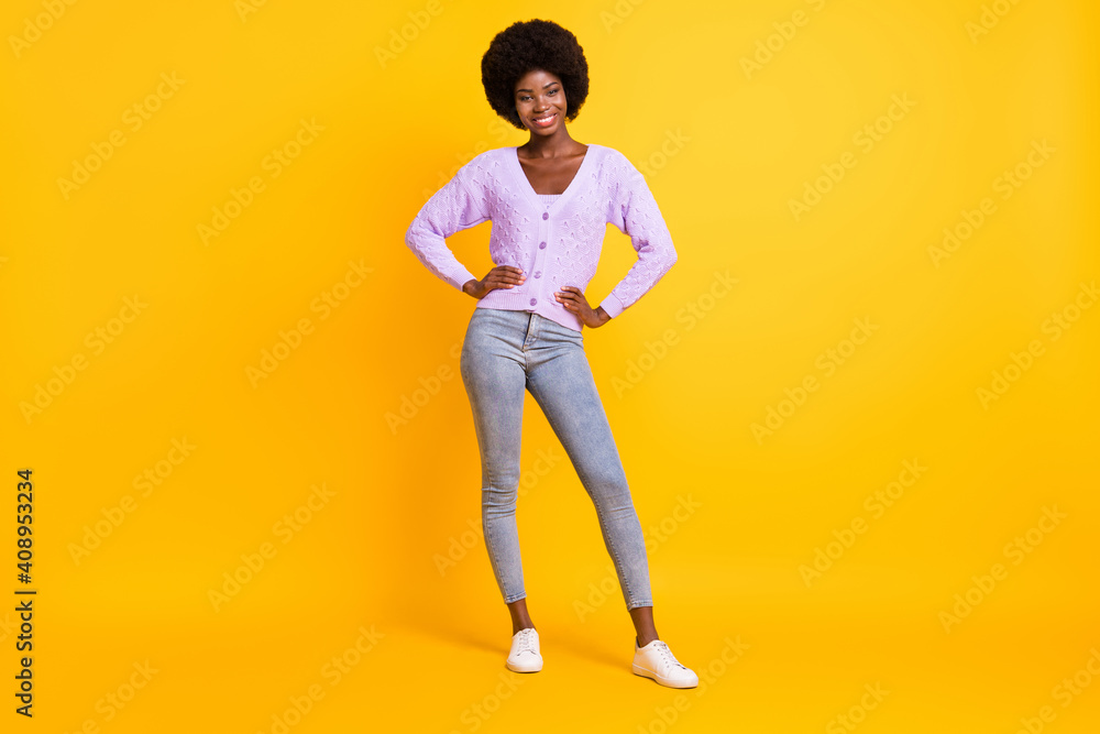 Full length photo of charming dark skin person put hands on waist wear violet outfit isolated on yellow color background Full length photo of charming dark skin person put hands on waist wear violet outfit isolated on yellow color background