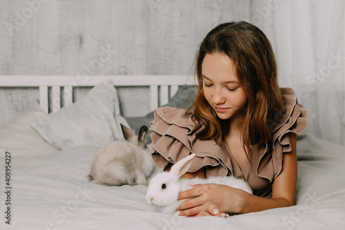 Girl and rabbits. Easter symbols, pets bunnies © Evgeniya Sheydt