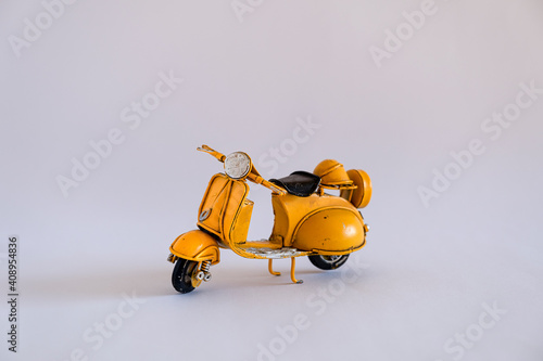 Old toy motorbike on different backgrounds