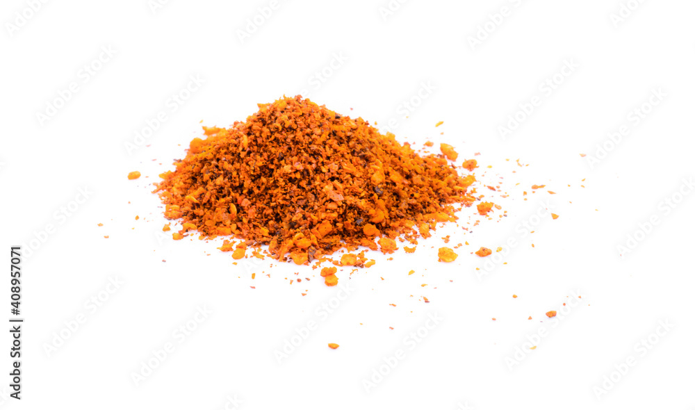 pile crushed red cayenne pepper, dried chili flakes and seeds on white background.