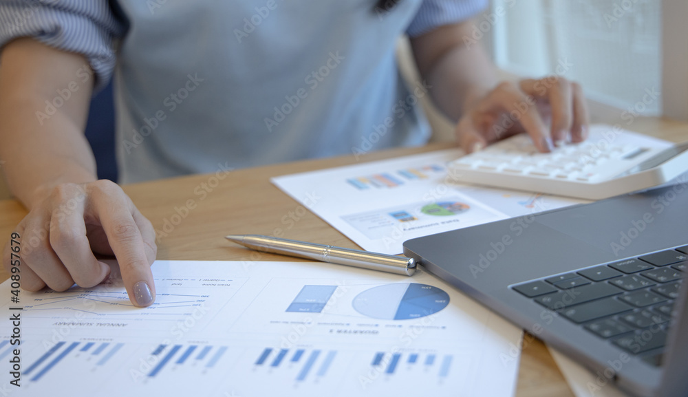 Financial businesswoman calculating corporate income tax data And analyzing charts of financial stocks that are in good condition with growth and progress, Investment in finance. Financial businesswoman calculating corporate income tax data And analyzing charts of financial stocks that are in good condition with growth and progress, Investment in finance.