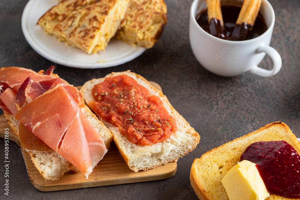 The most famous Spanish tapa for breakfast. Tortilla, tortilla, bruschetta with jamon and tomatoes, crusty toast with butter and jam. The most famous Spanish tapa for breakfast. Tortilla, tortilla, bruschetta with jamon and tomatoes, crusty toast with butter and jam.