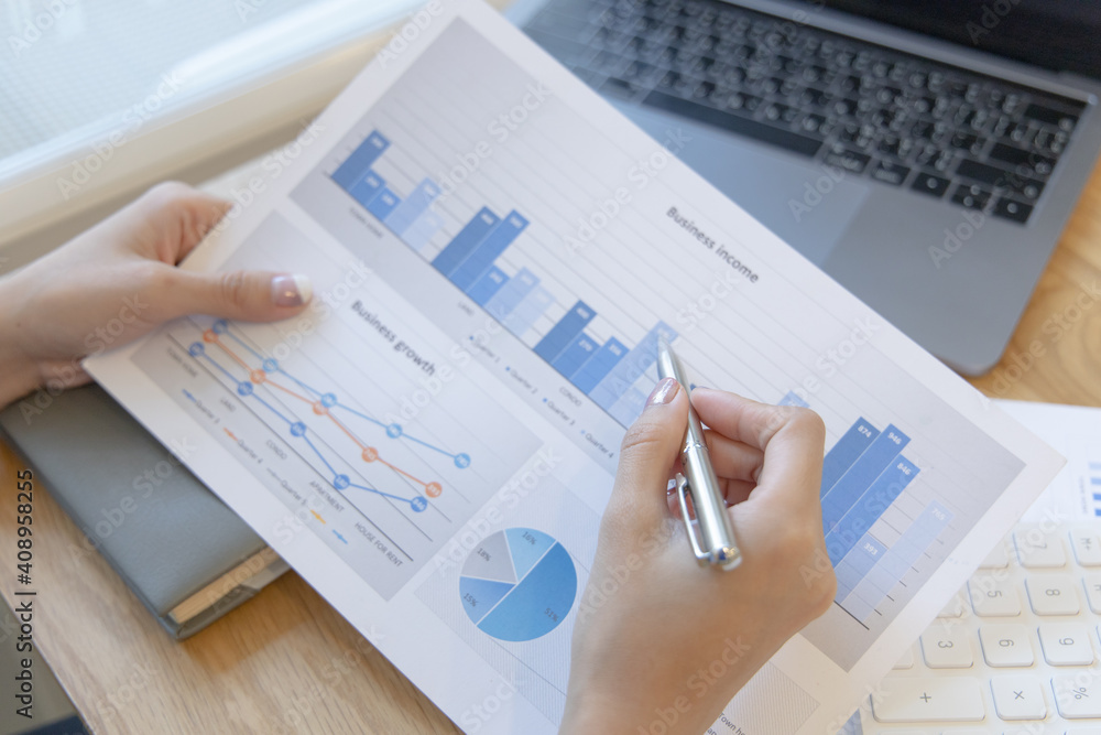 Financial businesswomen analyze the graph of the company's performance to create profits and growth, Market research reports and income statistics, Financial and Accounting concept. Financial businesswomen analyze the graph of the company's performance to create profits and growth, Market research reports and income statistics, Financial and Accounting concept.