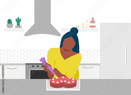 Beautiful black woman cooking sweet cake on kitchen table in kitchen. Girl cooking pie. Baking workshop. Freelance chef, pastry chef. Work from home. Stay at home on quarantine during the Coronavirus.