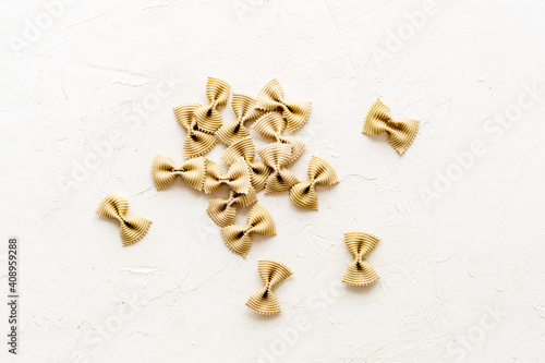 Top view of coloured farfalle pasta, space for text