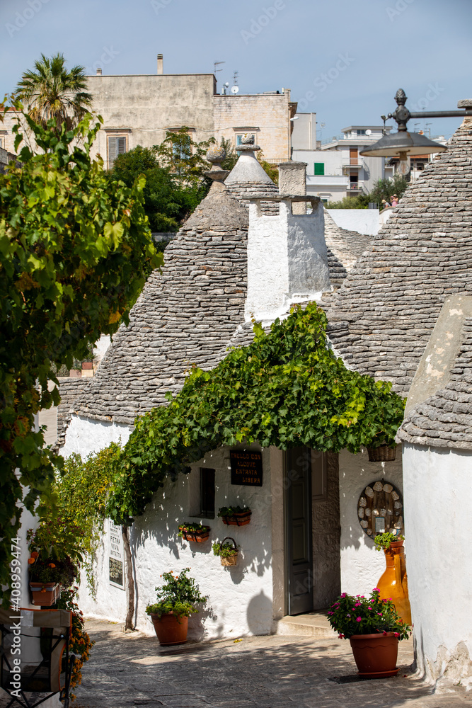 Fototapeta premium Tradtional white houses in Trulli village. Alberobello, Italy. The style of construction is specific to the Murge area of the Italian region of Apulia (in Italian Puglia). 