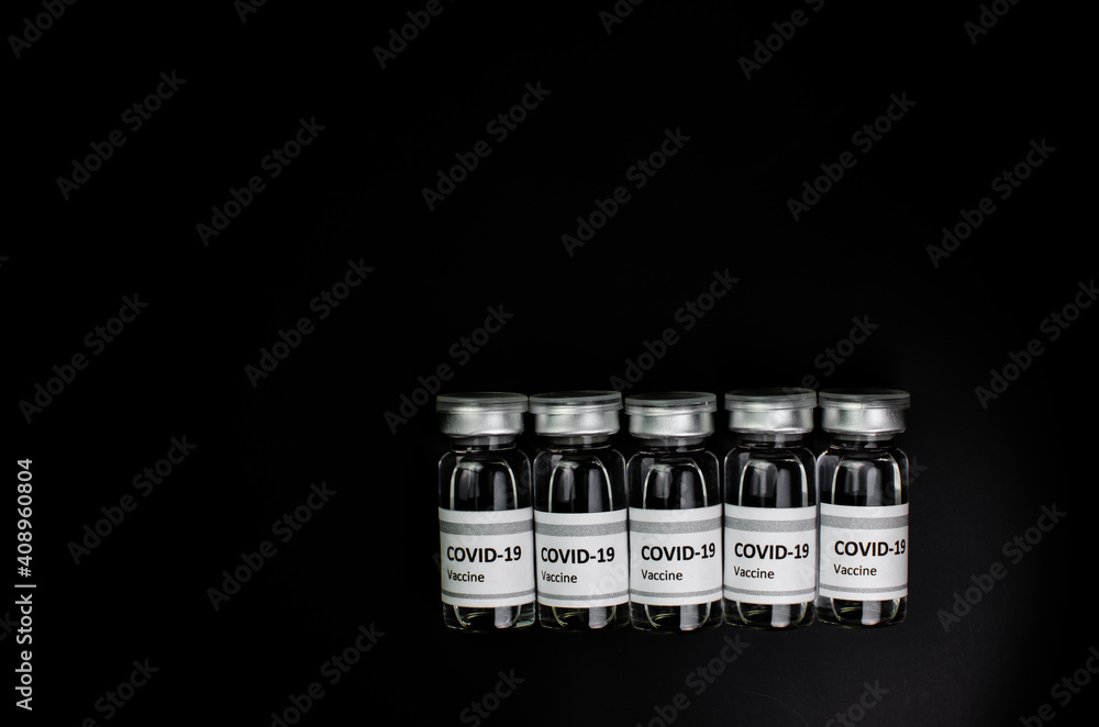 Coronavirus vaccine bottle flipped isolated on black background. Covid-19 situation disease pharmacy in laboratory and drug to cure people. Healthcare and Medical concept. Development of research. Coronavirus vaccine bottle flipped isolated on black background. Covid-19 situation disease pharmacy in laboratory and drug to cure people. Healthcare and Medical concept. Development of research.