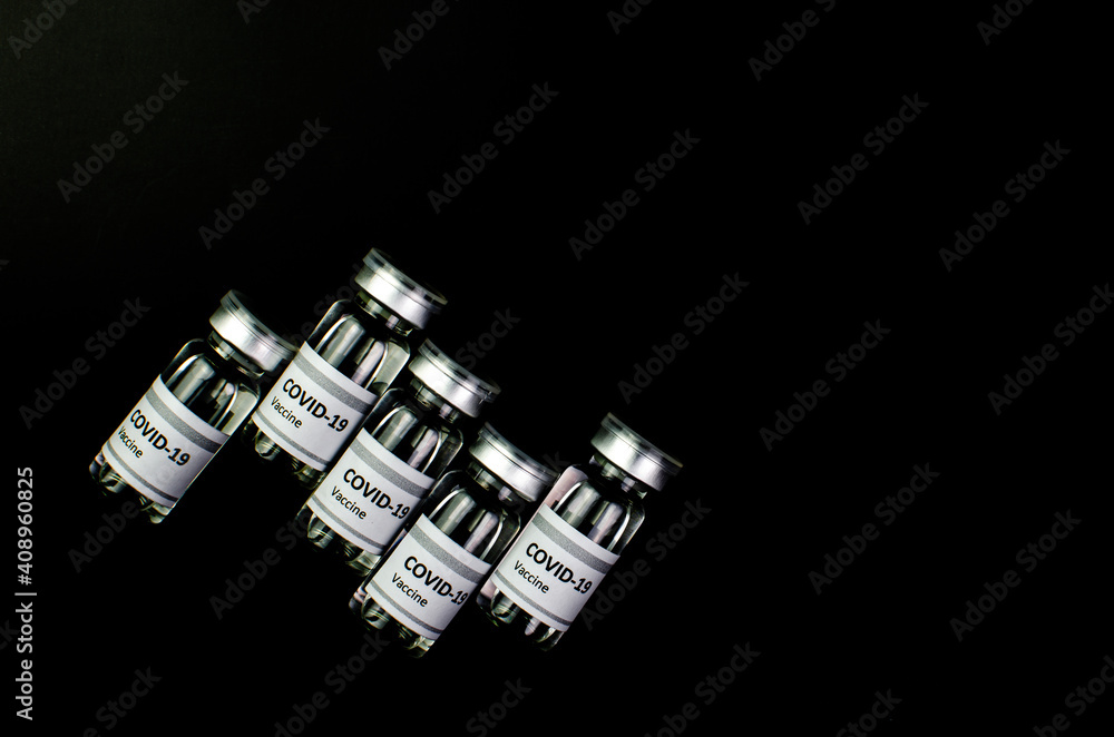 Coronavirus vaccine bottle flipped isolated on black background. Covid-19 situation disease pharmacy in laboratory and drug to cure people. Healthcare and Medical concept. Development of research. Coronavirus vaccine bottle flipped isolated on black background. Covid-19 situation disease pharmacy in laboratory and drug to cure people. Healthcare and Medical concept. Development of research.