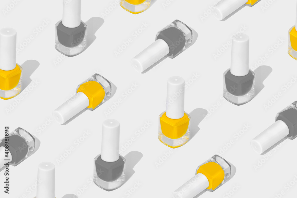 Pattern composition of nail polish on a white background. Colors of the year 2021. Set of shades of Illuminating and Ultimate Grey. Pattern composition of nail polish on a white background. Colors of the year 2021. Set of shades of Illuminating and Ultimate Grey.