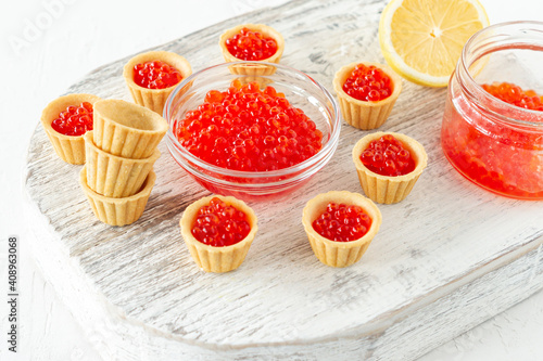 Tartlets with butter and red caviar. Gourmet food, appetizer. Delicatessen. Seafood.