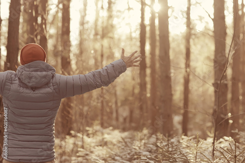 winter landscape forest backpack man / traveler in modern winter clothes in the forest, traveling in the mountains  europe, switzerland winter photo