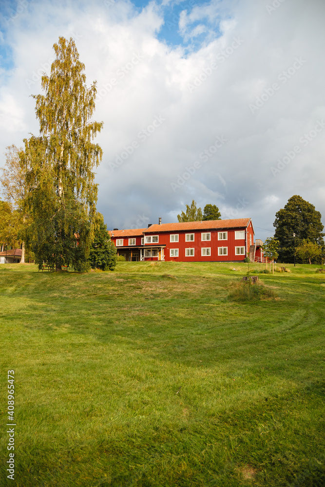 Red wooden house in Sweden. Wooden house in a youth hostel in Sweden. Swedish house with garden 