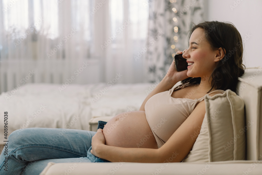 Happy charming pregnant woman using mobile phone. Pregnant Woman. Happy charming pregnant woman using mobile phone. Pregnant Woman.