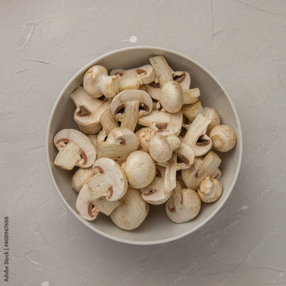 Fresh sliced mushrooms in a round porcelain bowl Fresh sliced mushrooms in a round porcelain bowl
