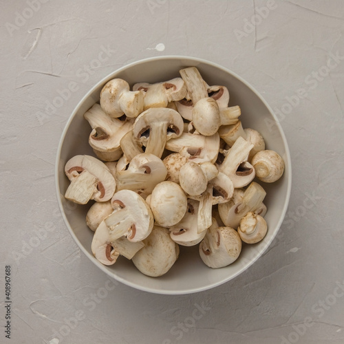 Fresh sliced mushrooms in a round porcelain bowl