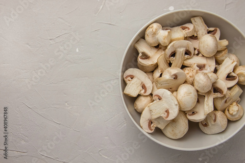 Whole and chopped fresh mushrooms in a white bowl