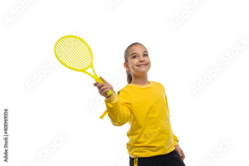 Studio portrait of a young girl in a yellow tracksuit with a tennis racket, izolated