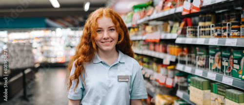Happy sales woman in modern supermarket