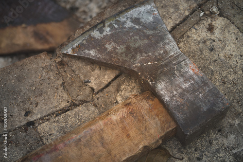 old rusty axe lies on stone tool logger horizontal macro photo