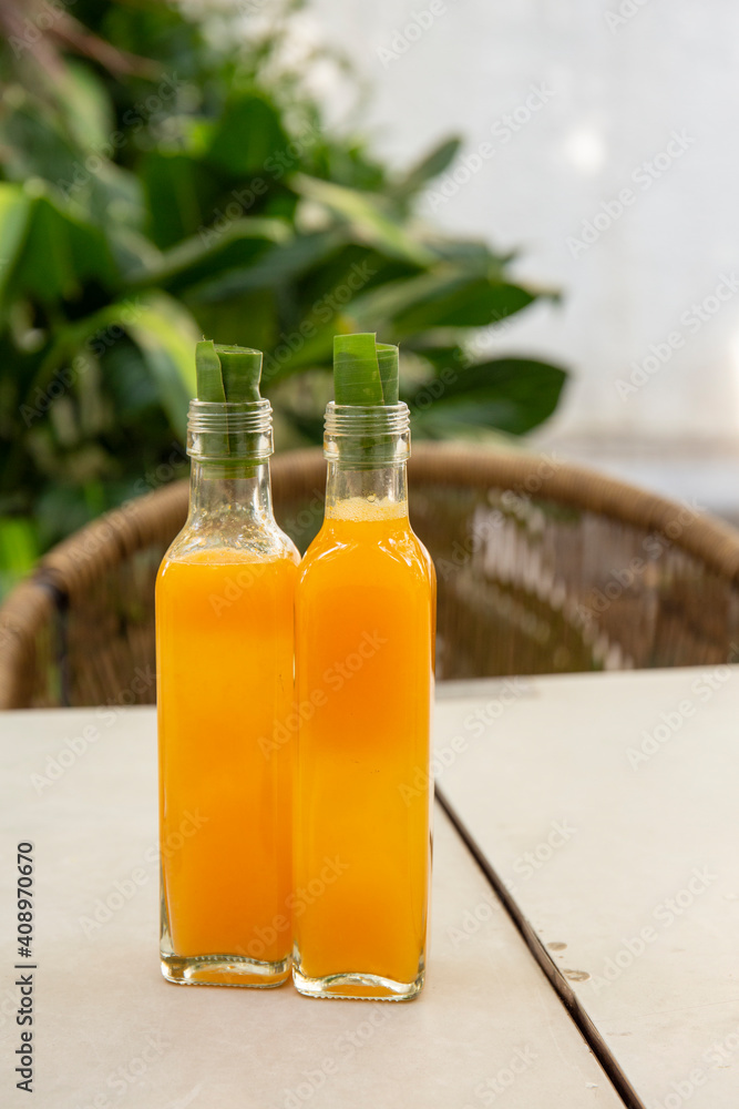 Bottle of Orange juice with cap made from banana leaf, Eco friendly concept Bottle of Orange juice with cap made from banana leaf, Eco friendly concept