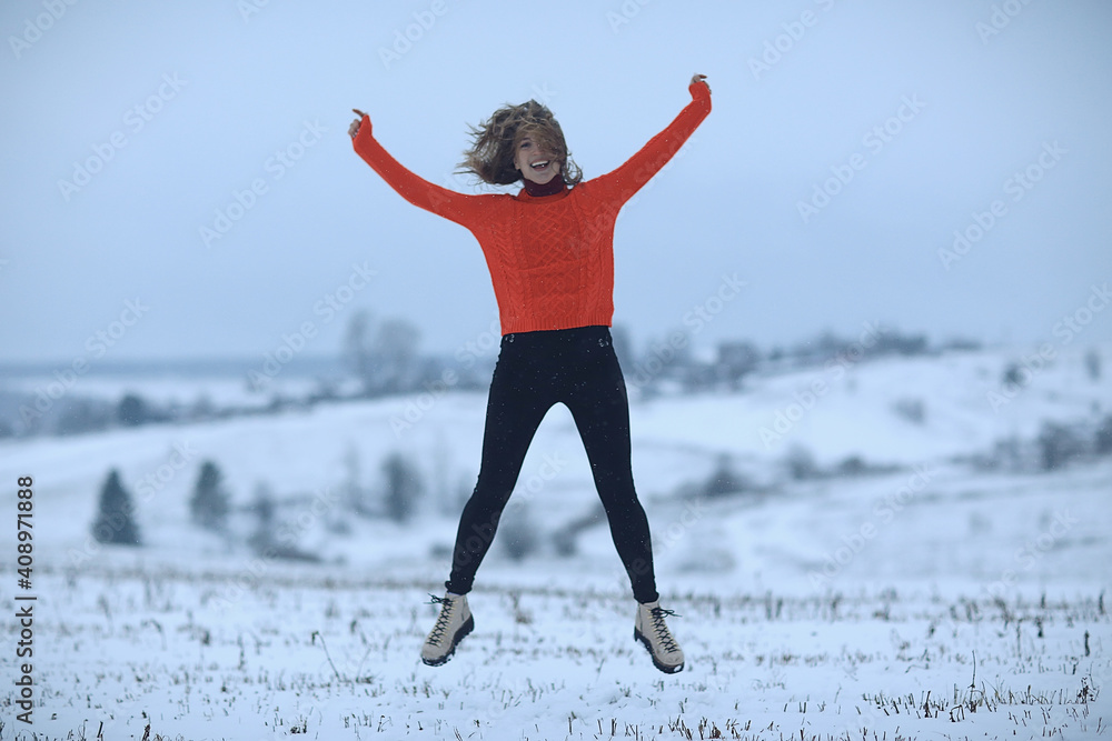 Fototapeta premium winter snow field woman happiness jumping and running in the field, new year holidays vacation freedom concept