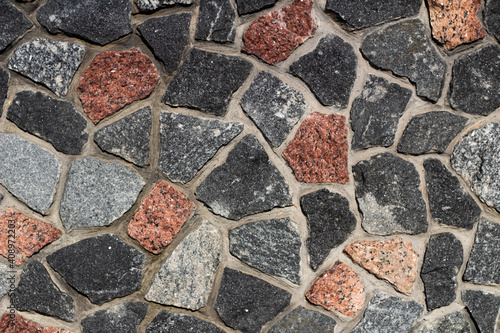 background multicolored red brown gray white black stones with gray cement