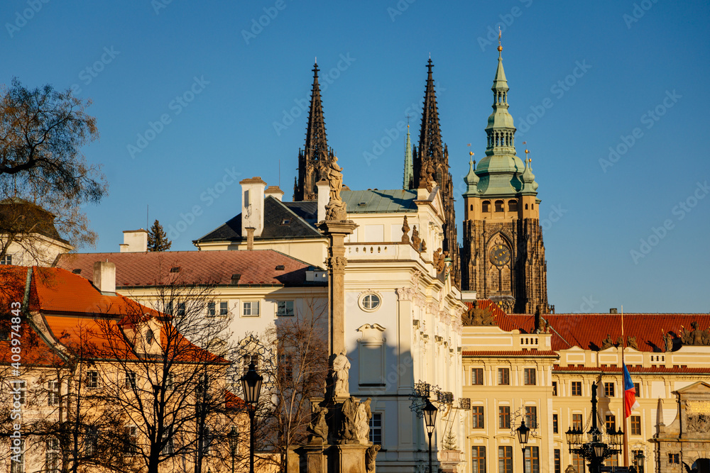 Fototapeta premium Castle from Hradcany Square, spiers of st Vitus cathedral, archbishop's palace and Marian Plague Column, sunny winter day, Hradcanske namesti, Prague, Czech Republic