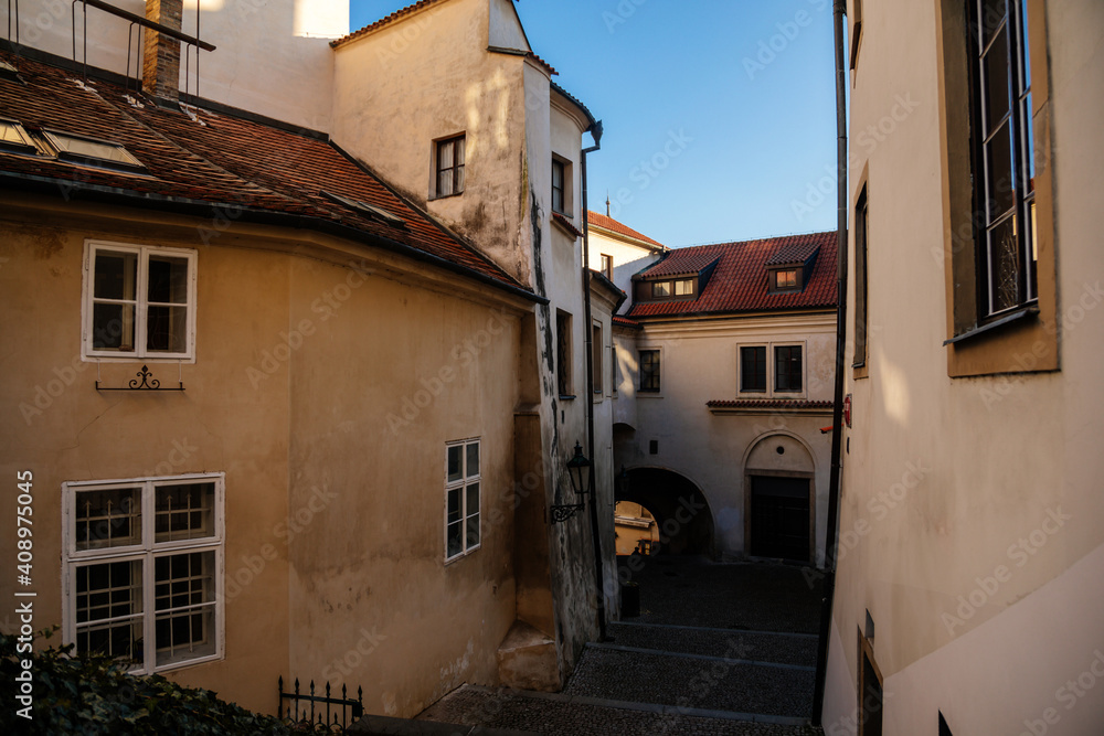 Fototapeta premium Town hall stairs, Fascinating narrow picturesque street with baroque and renaissance historical buildings, beautiful cityscape in sunny day, Hradcany, Prague, Czech Republic