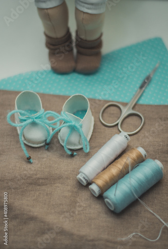 on the table lay a pair of scissors thread fabric for patchwork shoes and doll crafts classes quarantined