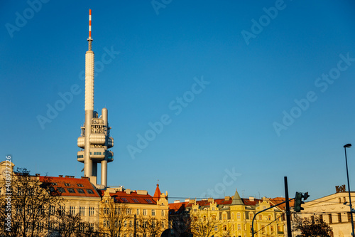 Panoramic view of Prague with red roofs and Zizkov television tower or Zizkovska vez in the background, Iconic tower in sunny day, Prague, Czech Republic photo