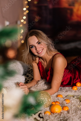 Blonde woman near fir tree for celebration of new year and Christmas. High quality photo