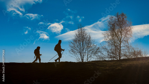 Mom with. child during hill walk on silhouette