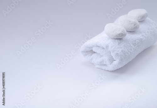 a white, terry towel with white stones on top.