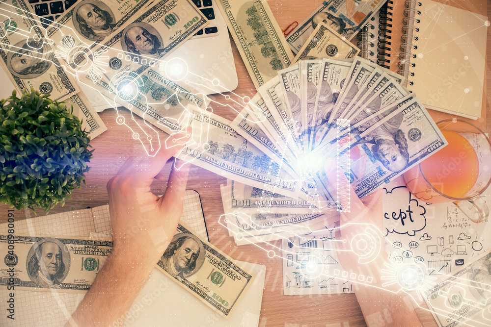 Multi exposure of technology drawing hologram and us dollars bills and man hands. Data concept Multi exposure of technology drawing hologram and us dollars bills and man hands. Data concept