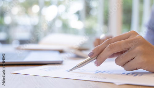Financial businesswomen analyze the graph of the company's performance to create profits and growth, Market research reports and income statistics, Financial and Accounting concept.