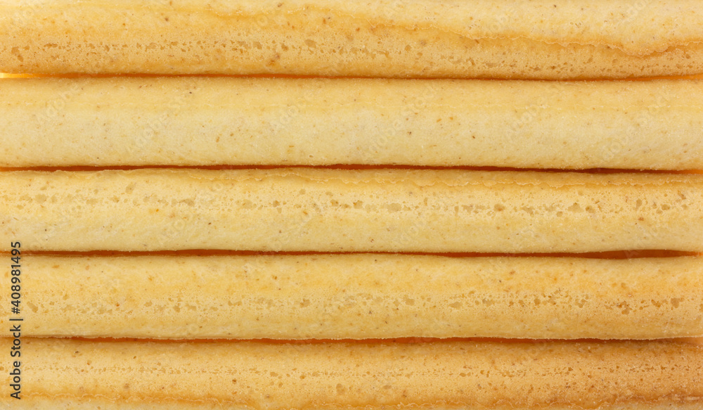 Close view of small dried breadsticks in rows. Close view of small dried breadsticks in rows.