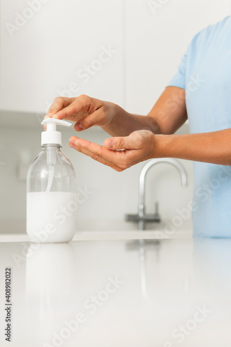 Woman using hand sanitizer or liquid soap for hands disinfection