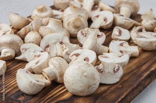 Whole and sliced mushrooms on a dark wooden board