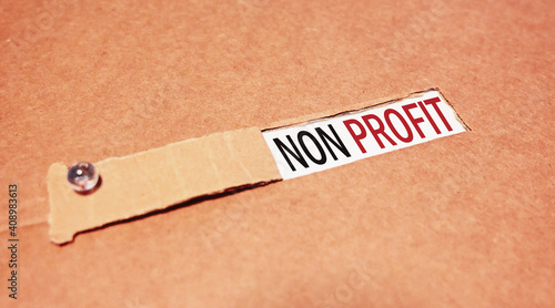 Photography Non Profit word written under torn paper.
