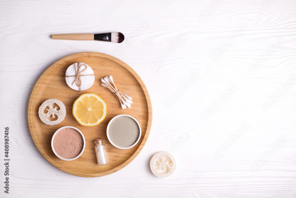 Cosmetic clay facial masks, sea salt and brush on white wooden background. Cosmetic clay facial masks, sea salt and brush on white wooden background.